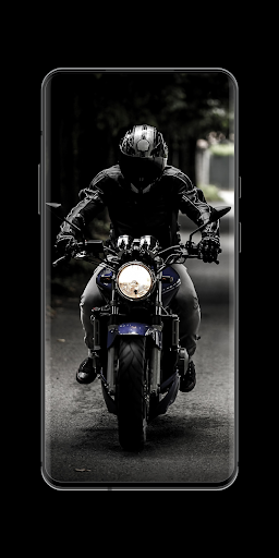 a person riding a motorcycle on a white surface with red and black paint  splattered on